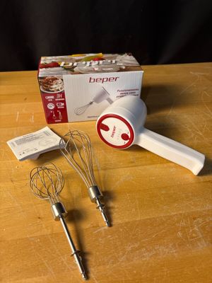 a whisk and a whisk on a table next to a box of whisks