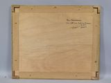an old wooden box with writing on it sitting on top of a table
