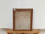 an old wooden easel with a piece of paper on top of it
