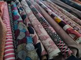 a lot of different colored fabrics on a table