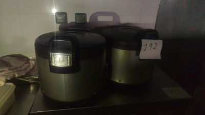 two rice cookers sitting on a counter in a kitchen