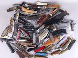a pile of different types of knives on a white surface