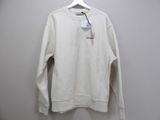 a white sweatshirt hanging on a hanger with a tag on it