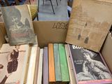 boxes of books are stacked on top of each other in a room