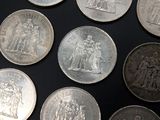 a lot of silver coins that are on a table