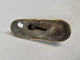 an antique bronze figurine of a dog with a bone in it ' s mouth