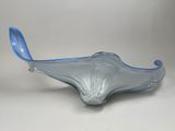 a close up of a blue glass bowl on a white surface