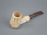 a small pipe with a wooden handle on a gray surface