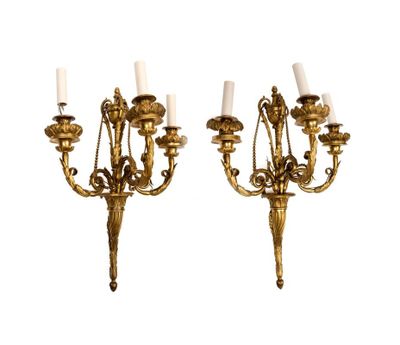 pair of antique brass wall sconces with white candles
