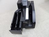 a printer that is sitting on the floor next to a cell phone