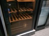 une cave à vin placée derrière une porte vitrée