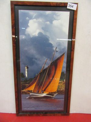a picture of a sailboat in a picture frame on the wall