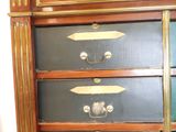 a black and gold chest of drawers in a room
