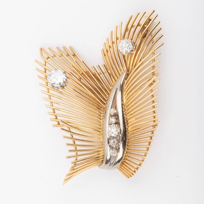 an image of a gold and diamond broochle on a white background