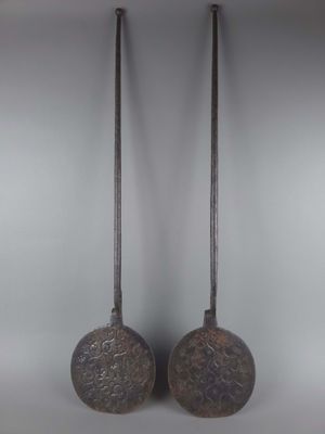une paire de clochettes en laiton ancien sur fond blanc