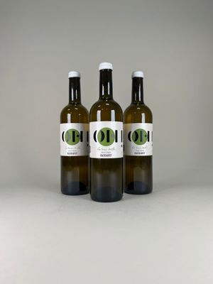 three bottles of olive oil on a white surface