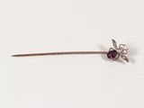 a silver stick with a red flower on it