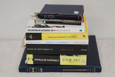 books stacked on top of each other on a white surface