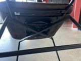 a baby stroller that is sitting on a metal stand