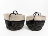 two black and white baskets with handles on a white background