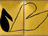 yellow and black paintings on a wall in a room