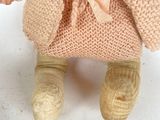 a teddy bear that is wearing a sweater and shoes