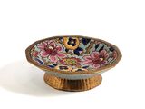 a small bowl that has a flower design on it