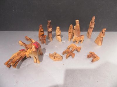 a lot of wooden figurines that are on a table