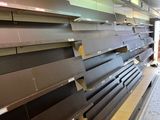 a lot of empty shelves in a store that is empty