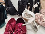 several pairs of women ' s shoes are lined up on a table