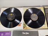 an image of two black vinyl records sitting on top of a table