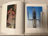 an open book with a picture of a knife and a picture of a woman in a pink dress