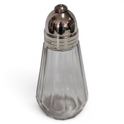 a glass salt and pepper shaker on a white surface
