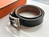 a belt that is sitting on a table next to a box