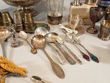 a table with a lot of silverware on it