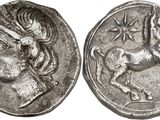 a silver coin with an image of a horse on it