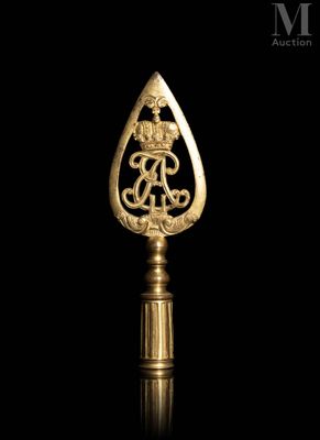an image of a gold bottle opener with a dragon on it