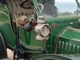 a close up of a green car with a light on it