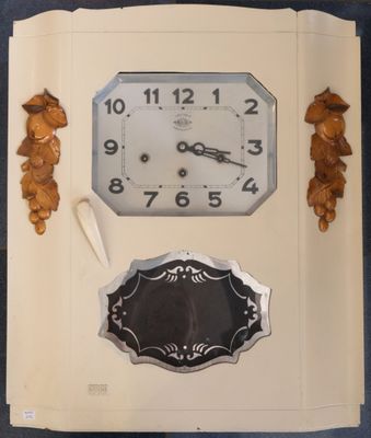 a clock that is sitting on a book with leaves around it