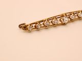 a close up of a gold and diamond broochle