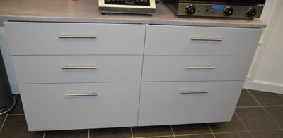 a microwave sitting on top of a dresser next to a toaster oven