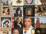 many different album covers on the wall of this room