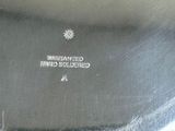 a silver plate with a logo on it on a table
