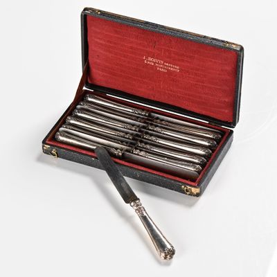 a box with six pens in it on a white surface
