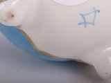 a white and blue piggy bank sitting on a table