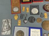 a lot of medals and other items on the table