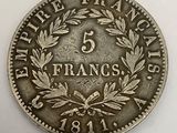 a close up of a coin with a wreath on it