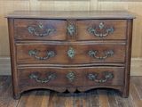 a wooden chest of drawers on a wooden floor