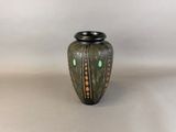 an image of a vase with a green and black design