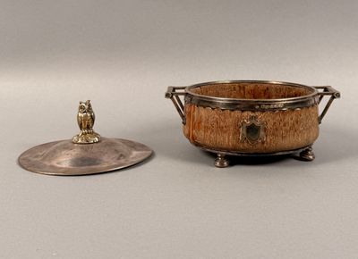 a small metal bowl with a lid next to a smaller metal bowl
